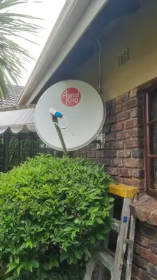 Aerial King satellite dish installed on brick wall